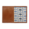 Wallet with brown leather section and blue palm tree patterned interior on a white background