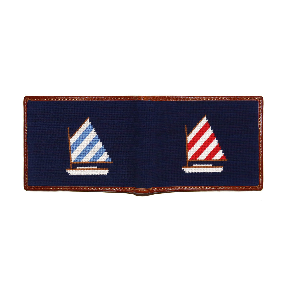 Navy needlepoint patch with sailboat designs on a white background
