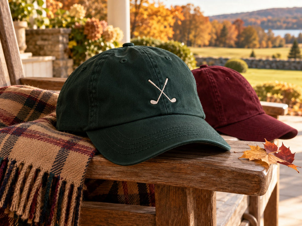 Hunter green golf motif cap and burgundy cap in warm autumn light
